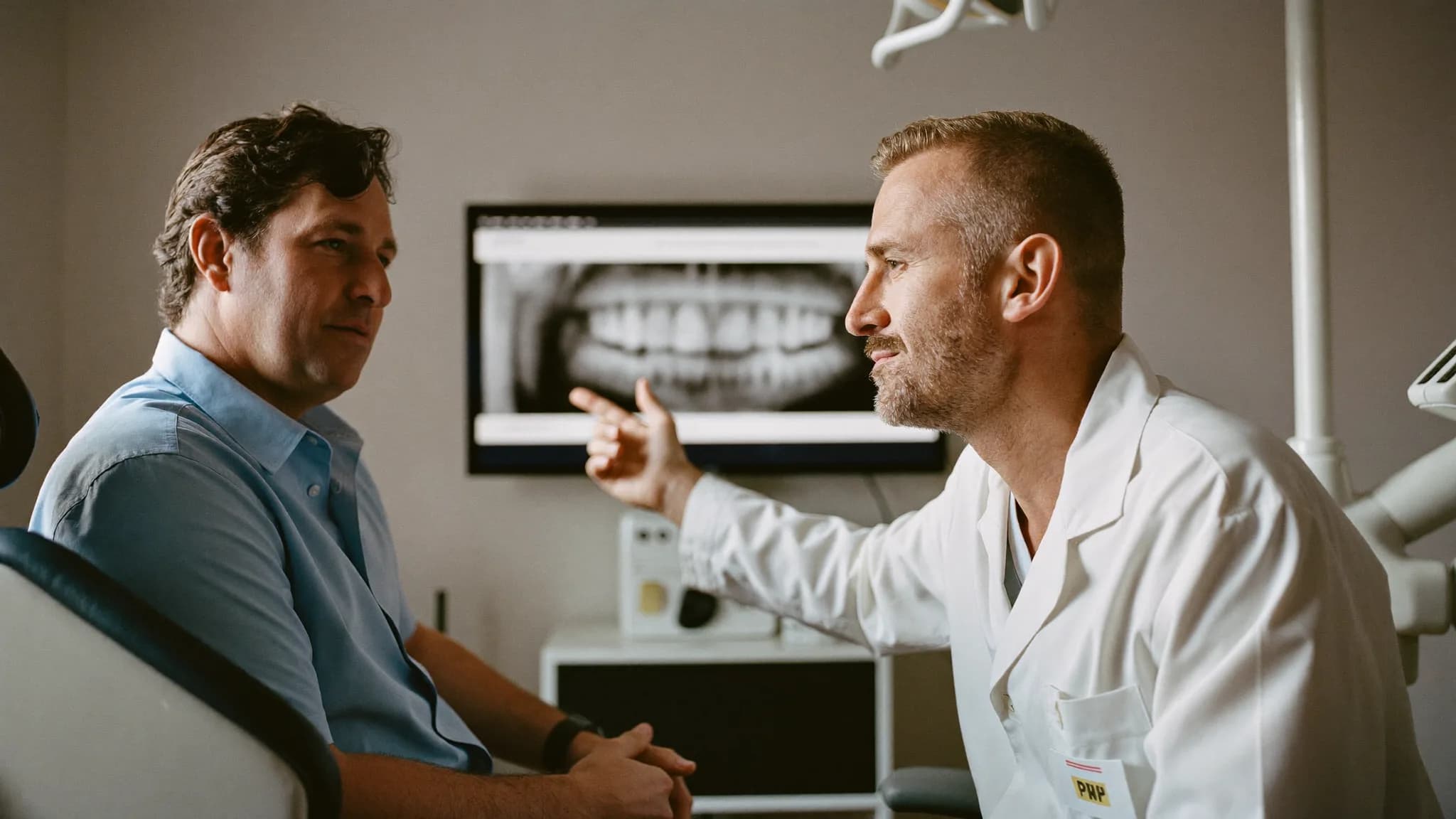 Dentist discussing tooth extraction options with a patient at Good Morning Dental