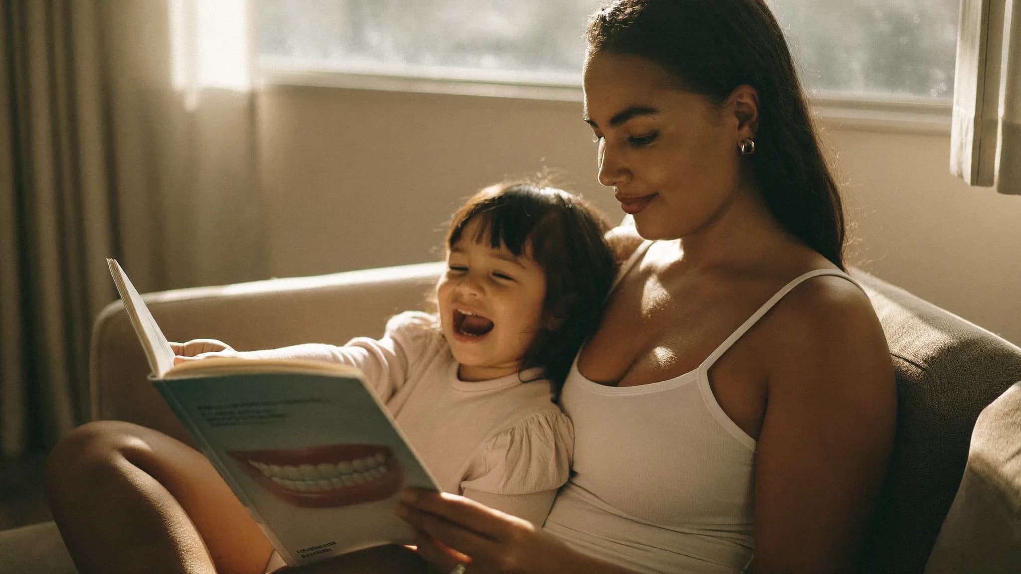 Child smiling with a mix of baby and adult teeth at Good Morning Dental
